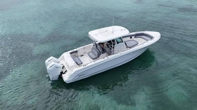  Yacht Photos Pics 2025 Boston Whaler 330 Outrage boat on clear turquoise water.