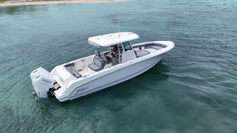  Yacht Photos Pics 2025 Boston Whaler 330 Outrage boat on clear blue water.