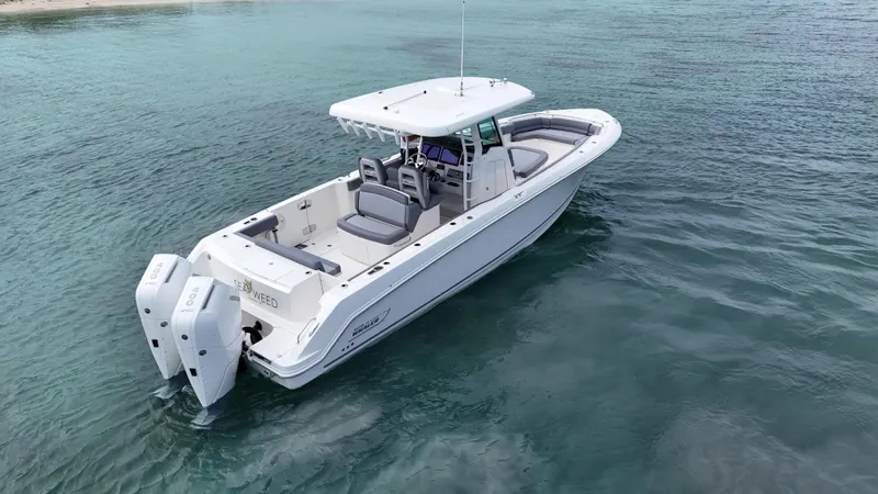  Yacht Photos Pics 2025 Boston Whaler 330 Outrage boat on clear blue water.