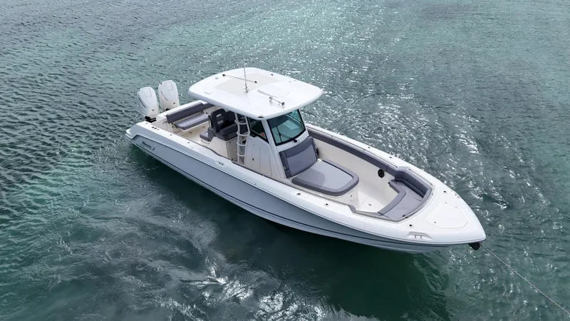  Yacht Photos Pics 2025 Boston Whaler 330 Outrage boat on clear ocean water.