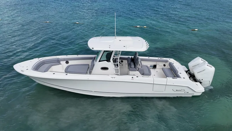  Yacht Photos Pics 2025 Boston Whaler 330 Outrage boat on clear blue water.