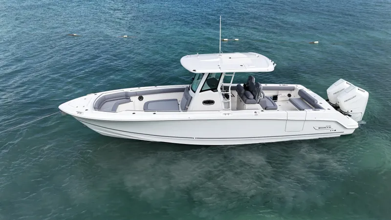  Yacht Photos Pics 2025 Boston Whaler 330 Outrage boat on clear blue water.