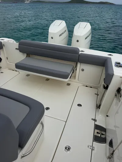  Yacht Photos Pics 2025 Boston Whaler 330 Outrage boat interior with seating and twin Mercury engines.