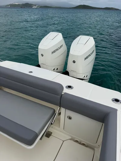  Yacht Photos Pics 2025 Boston Whaler 330 Outrage with twin Mercury engines on calm water.