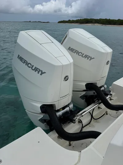  Yacht Photos Pics 2025 Boston Whaler 330 Outrage with twin Mercury outboard engines on calm water.