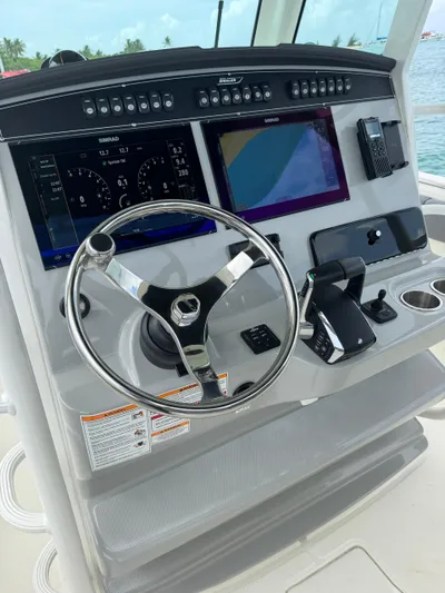  Yacht Photos Pics 2025 Boston Whaler 330 Outrage helm with advanced navigation displays and controls.