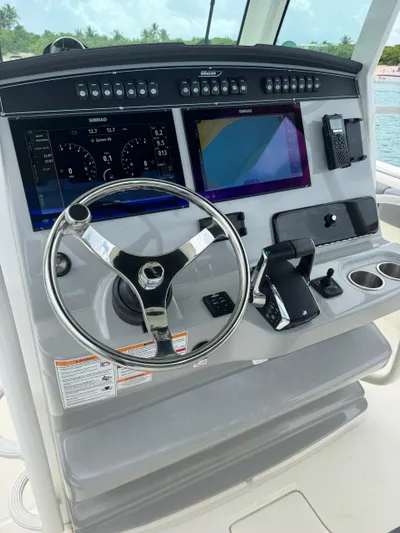  Yacht Photos Pics 2025 Boston Whaler 330 Outrage helm with advanced navigation displays and controls.