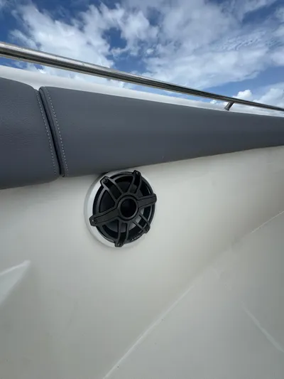 Yacht Photos Pics 2025 Boston Whaler 330 Outrage boat speaker and railing under blue sky.
