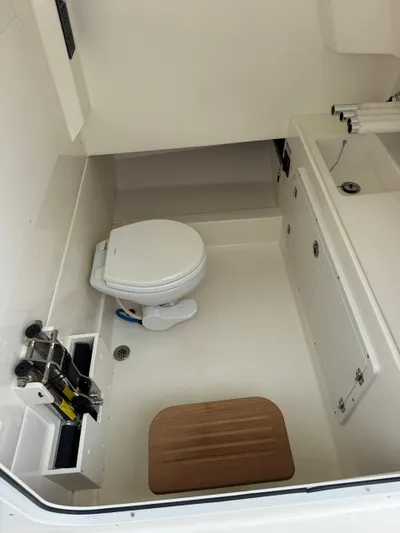  Yacht Photos Pics 2025 Boston Whaler 330 Outrage boat interior with toilet and sink.