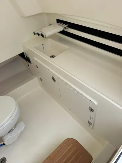  Yacht Photos Pics 2025 Boston Whaler 330 Outrage interior bathroom with sink and toilet.