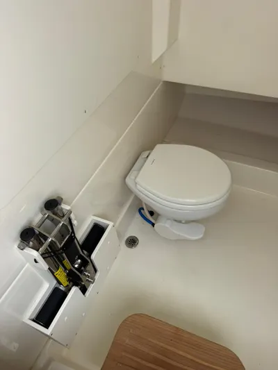  Yacht Photos Pics 2025 Boston Whaler 330 Outrage boat interior with toilet and storage compartment.