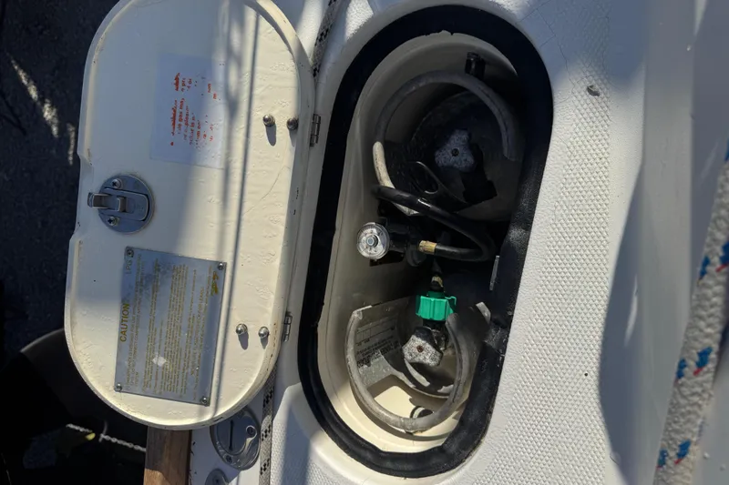 Lady Slipper Yacht Photos Pics Open storage compartment on a 2005 Sabre 386 boat, showing gas connections and safety labels.