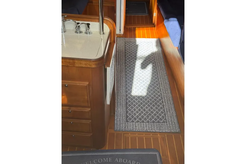 Lady Slipper Yacht Photos Pics Interior of 2005 Sabre 386 yacht with wooden flooring and patterned rug.