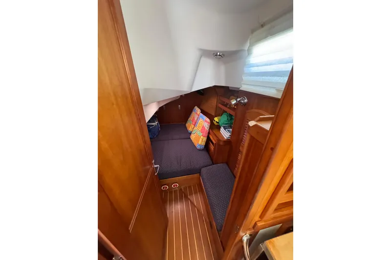 Lady Slipper Yacht Photos Pics Cozy cabin interior of 2005 Sabre 386 sailboat with colorful cushions and wooden finish.