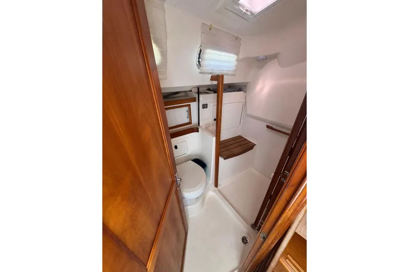 Lady Slipper Yacht Photos Pics 2005 Sabre 386 yacht bathroom with wooden accents and compact design.