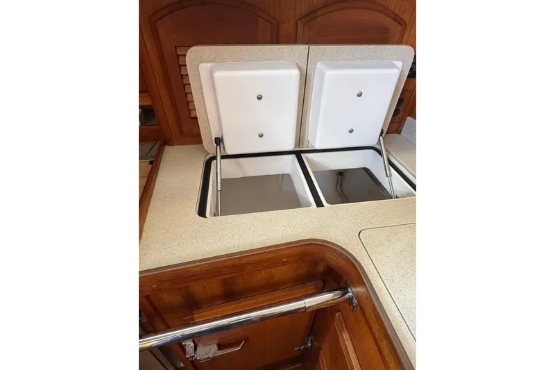 Lady Slipper Yacht Photos Pics 2005 Sabre 386 yacht kitchen with dual compartment storage and wooden cabinetry.