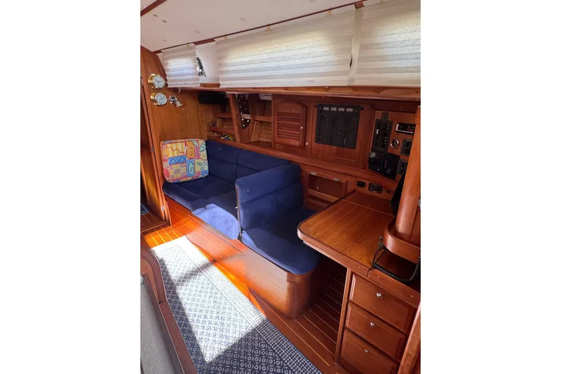 Lady Slipper Yacht Photos Pics Interior of 2005 Sabre 386 yacht with blue seating and wooden cabinetry.