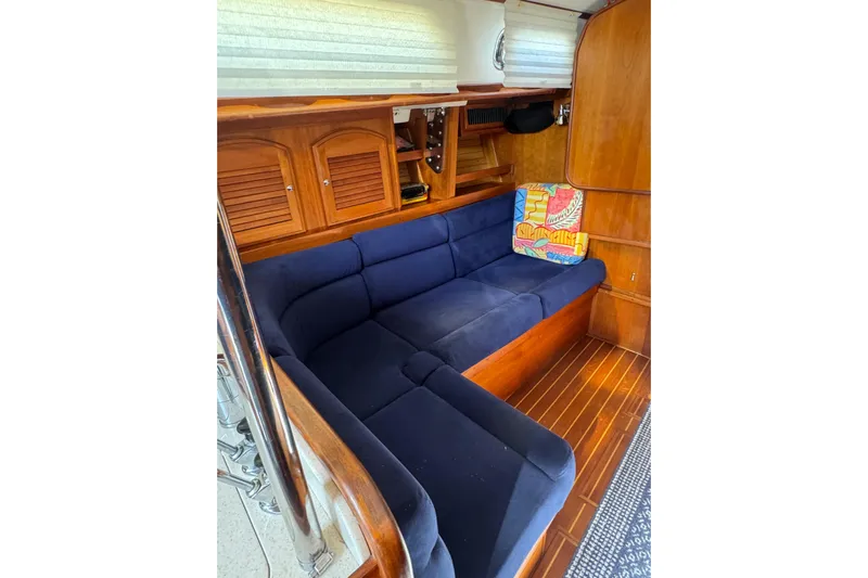 Lady Slipper Yacht Photos Pics Interior of 2005 Sabre 386 yacht with blue cushioned seating and wooden cabinetry.