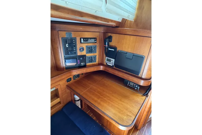 Lady Slipper Yacht Photos Pics Navigation station of 2005 Sabre 386 sailboat with control panels and communication equipment.