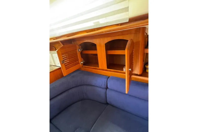 Lady Slipper Yacht Photos Pics Interior of 2005 Sabre 386 yacht with wooden cabinets and blue seating.