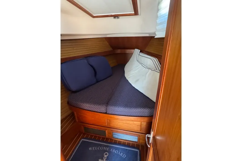Lady Slipper Yacht Photos Pics Cozy cabin interior of 2005 Sabre 386 yacht with wooden finish and comfortable bedding.