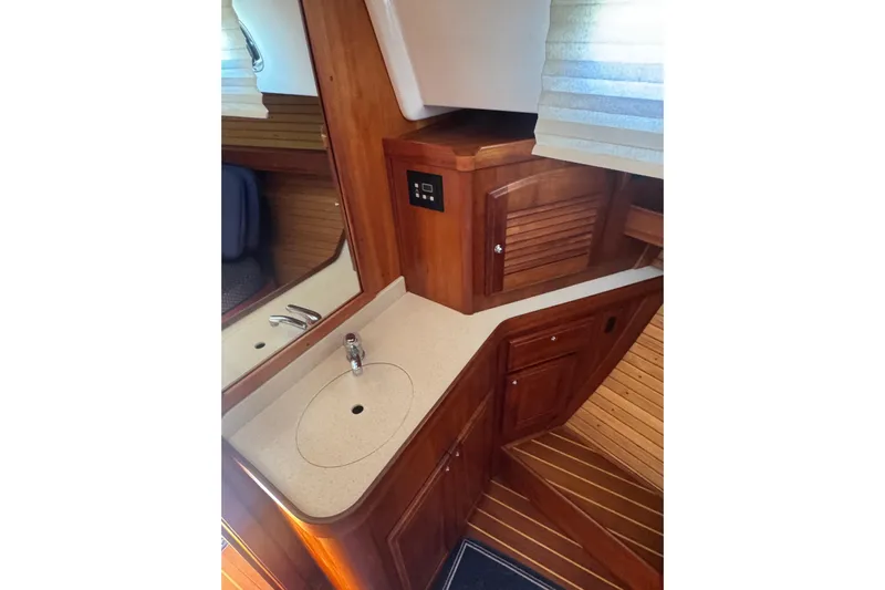 Lady Slipper Yacht Photos Pics 2005 Sabre 386 yacht interior with wooden cabinetry and compact sink area.