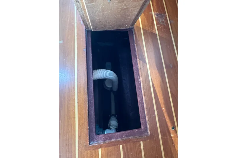 Lady Slipper Yacht Photos Pics Wooden boat floor compartment with visible plumbing, Sabre 386, 2005 model.