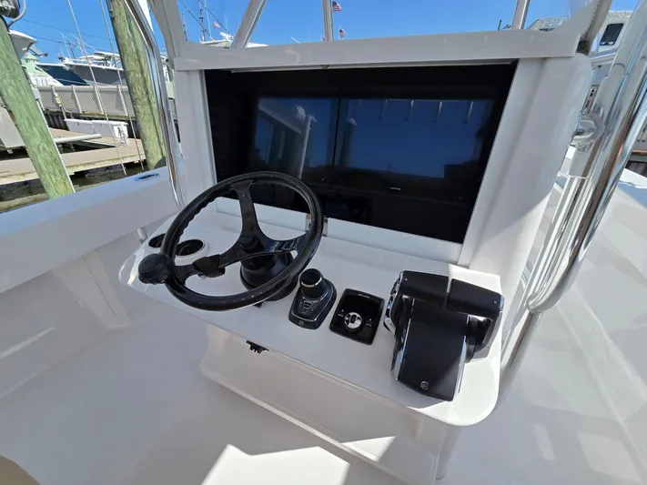  Yacht Photos Pics Center console of 2025 Bahama 35 Super, featuring steering wheel and controls.