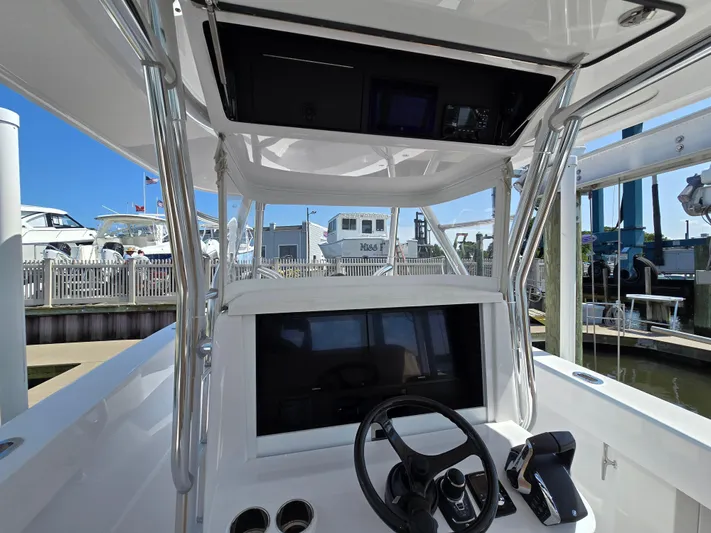  Yacht Photos Pics 2025 Bahama 35 Super Center Console boat helm with steering wheel and controls.