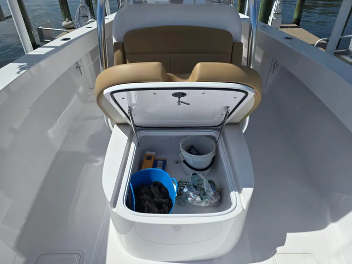  Yacht Photos Pics 2025 Bahama 35 Super Center Console storage compartment with open hatch, showcasing interior items.