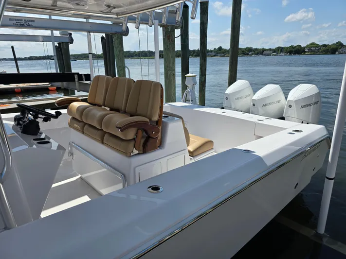  Yacht Photos Pics 2025 Bahama 35 Super Center Console boat with triple Mercury engines docked by the water.