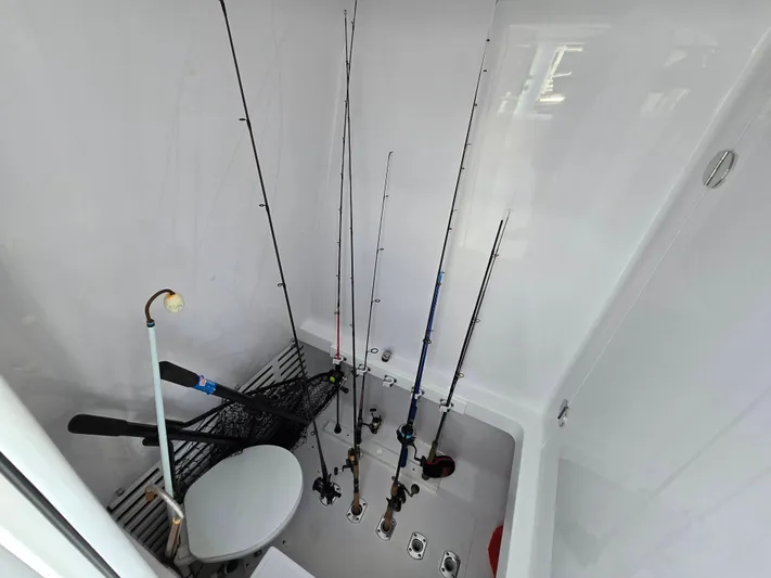  Yacht Photos Pics Fishing rods and gear stored in 2025 Bahama 35 Super Center Console boat compartment.