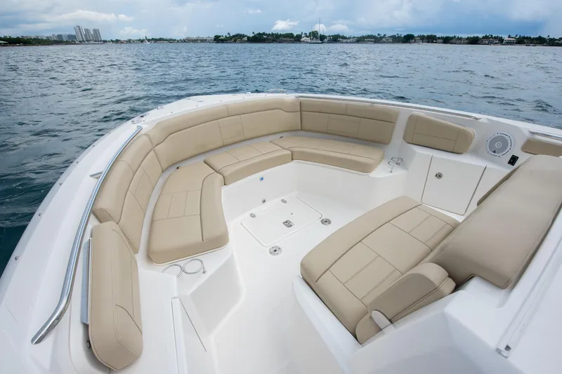 Southern Pass Yacht Photos Pics 2019 Pursuit S 328 Sport boat with spacious beige seating on open water.