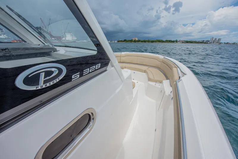 Southern Pass Yacht Photos Pics 2019 Pursuit S 328 Sport boat on open water, showcasing sleek design and spacious seating.