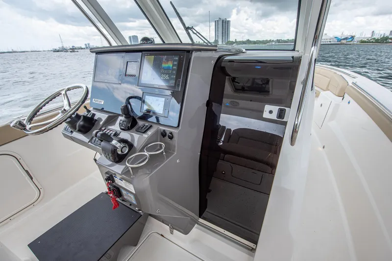 Southern Pass Yacht Photos Pics 2019 Pursuit S 328 Sport boat helm with modern controls and navigation screens.