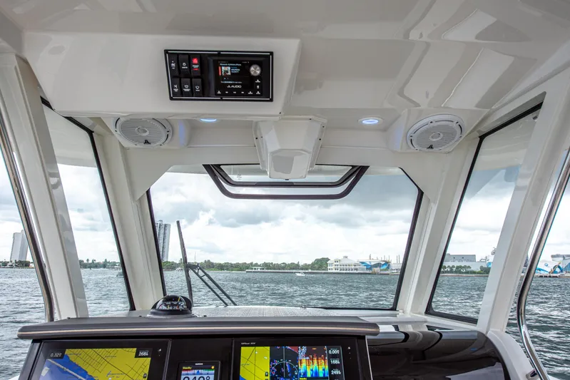 Southern Pass Yacht Photos Pics 2019 Pursuit S 328 Sport boat interior with navigation screens and water view.