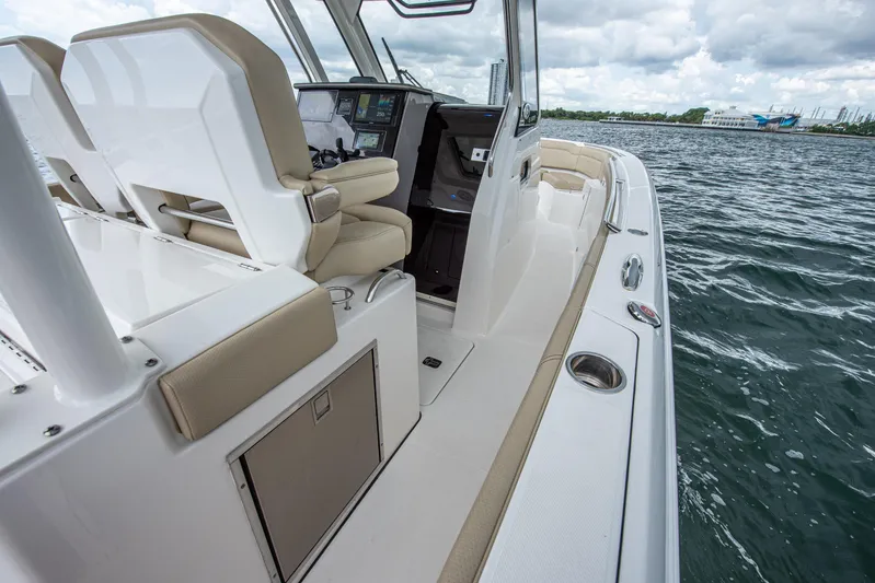 Southern Pass Yacht Photos Pics 2019 Pursuit S 328 Sport boat interior with helm and seating, on calm waters.