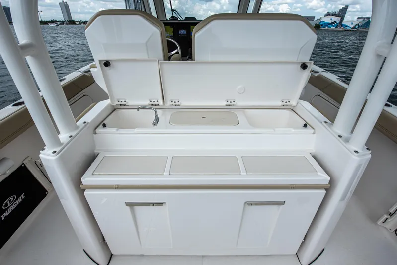 Southern Pass Yacht Photos Pics 2019 Pursuit S 328 Sport boat interior with sink and storage compartments.