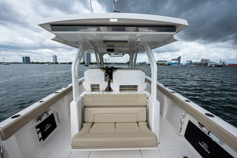 Southern Pass Yacht Photos Pics 2019 Pursuit S 328 Sport boat interior with seating, on a cloudy day by the water.