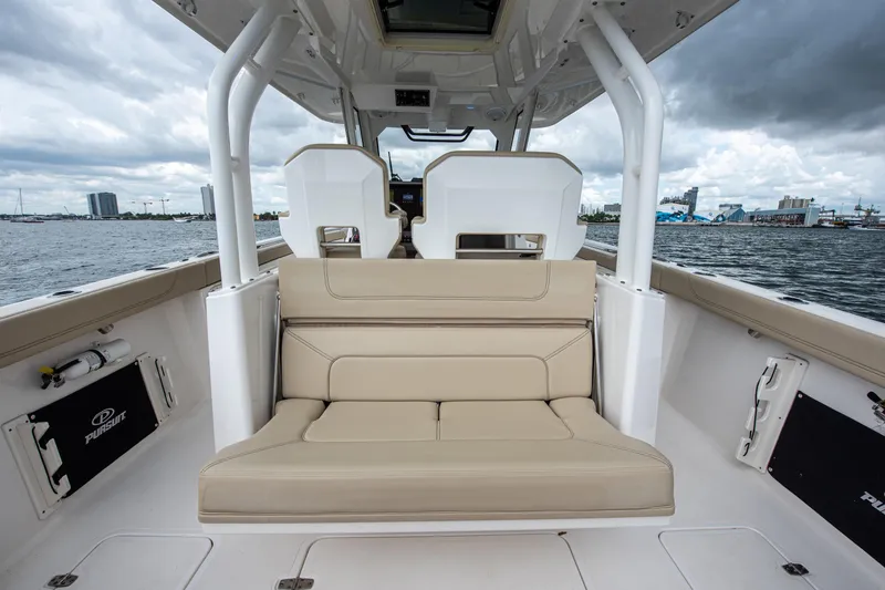 Southern Pass Yacht Photos Pics 2019 Pursuit S 328 Sport boat interior with beige seating and ocean view.