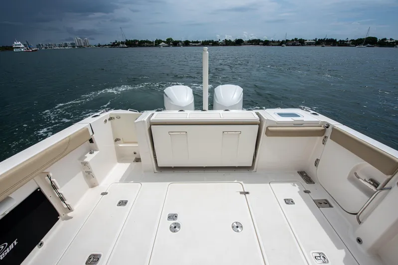 Southern Pass Yacht Photos Pics 2019 Pursuit S 328 Sport boat deck with dual engines on a calm waterway.