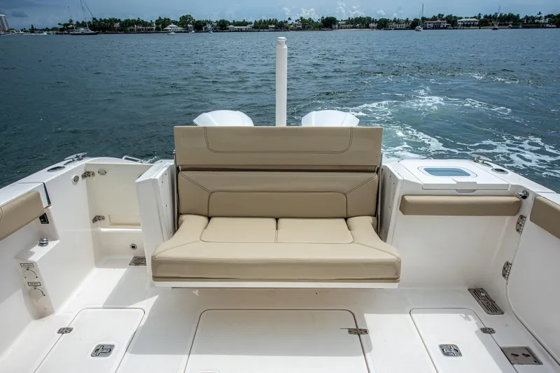 Southern Pass Yacht Photos Pics 2019 Pursuit S 328 Sport boat with beige seating, cruising on open water.