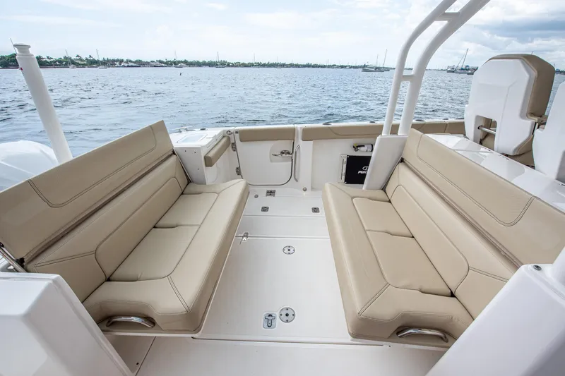 Southern Pass Yacht Photos Pics 2019 Pursuit S 328 Sport boat interior with beige seating, overlooking calm waters.