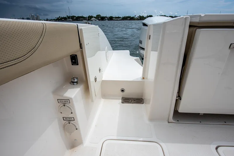 Southern Pass Yacht Photos Pics 2019 Pursuit S 328 Sport boat deck with water access and storage compartments.