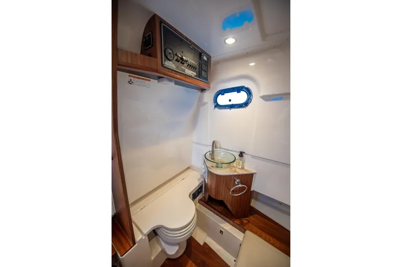 Southern Pass Yacht Photos Pics 2019 Pursuit S 328 Sport boat interior with compact bathroom and modern amenities.