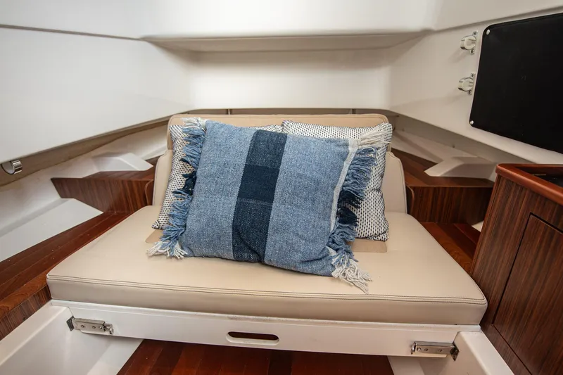 Southern Pass Yacht Photos Pics 2019 Pursuit S 328 Sport interior with cushioned seating and decorative pillows.