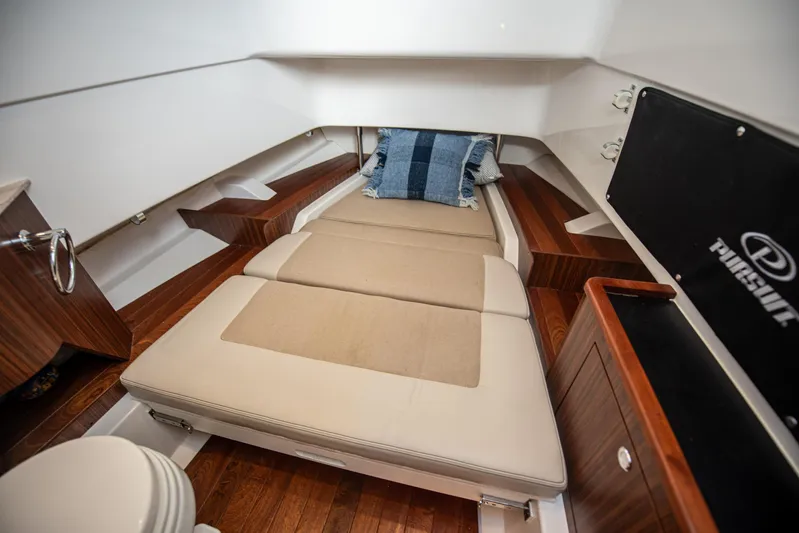 Southern Pass Yacht Photos Pics 2019 Pursuit S 328 Sport cabin interior with bed and wooden accents.