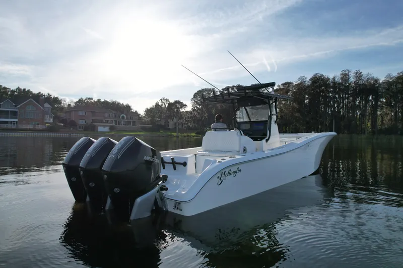  Yacht Photos Pics 2009 Yellowfin 36 Offshore boat on calm water, with triple Mercury engines.