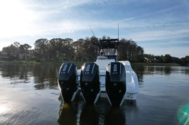  Yacht Photos Pics 2009 Yellowfin 36 Offshore boat with triple 300 V8 engines on a calm lake.