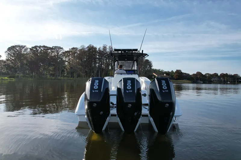  Yacht Photos Pics 2009 Yellowfin 36 Offshore boat with triple 300 V8 engines on a calm lake.